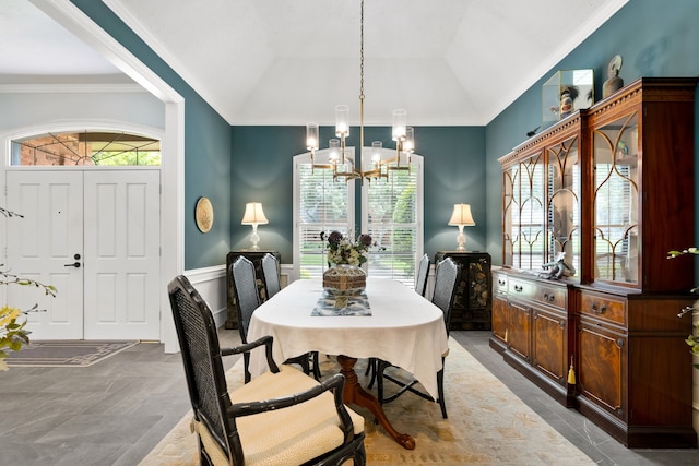 5701 Buffridge Trl, Dallas, TX 75252 - dining room featuring a chandelier, ornamental molding, lofted ceiling, and a wainscoted wall