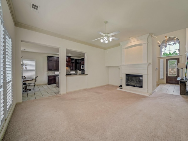 8009 Marathon Dr, Plano, TX 75024 - unfurnished living room featuring light colored carpet, ornamental molding, a chandelier, a fireplace, and light tile patterned floors