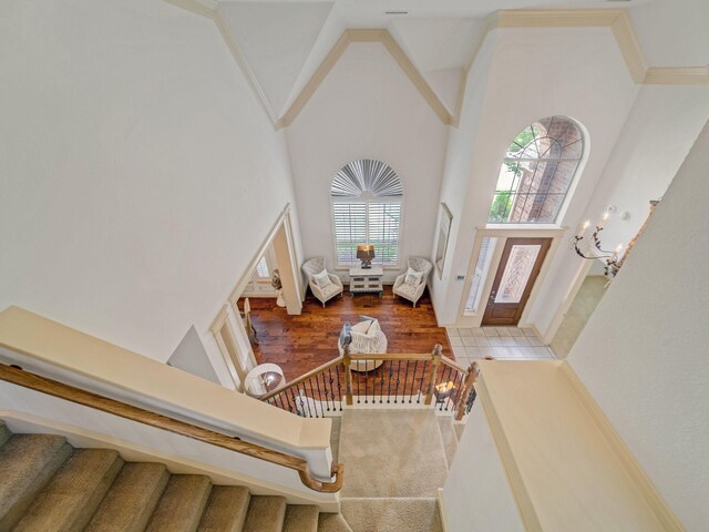 8009 Marathon Dr, Plano, TX 75024 - foyer featuring a high ceiling, stairs, ornamental molding, and wood finished floors