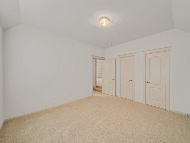 8009 Marathon Dr, Plano, TX 75024 - unfurnished bedroom featuring lofted ceiling, carpet floors, and two closets