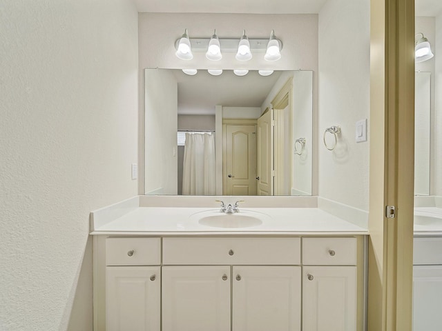 8009 Marathon Dr, Plano, TX 75024 - bathroom with vanity and a textured wall