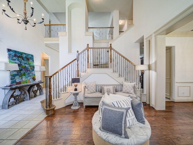 8009 Marathon Dr, Plano, TX 75024 - living room featuring a chandelier, a towering ceiling, hardwood / wood-style flooring, and stairway
