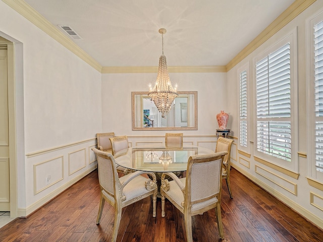 8009 Marathon Dr, Plano, TX 75024 - dining space with a chandelier, wood-type flooring, a decorative wall, a wainscoted wall, and ornamental molding