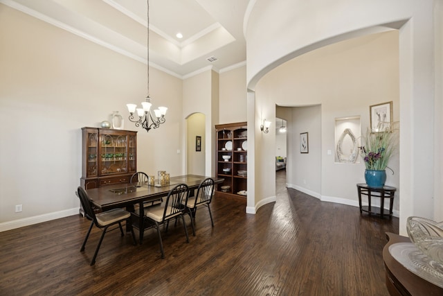 235 Bearclaw Cir, Aledo, TX 76008 - dining room with arched walkways, a towering ceiling, dark wood-style floors, a chandelier, and baseboards