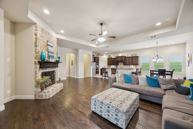 235 Bearclaw Cir, Aledo, TX 76008 - living area with a tray ceiling, a fireplace, a ceiling fan, arched walkways, and recessed lighting