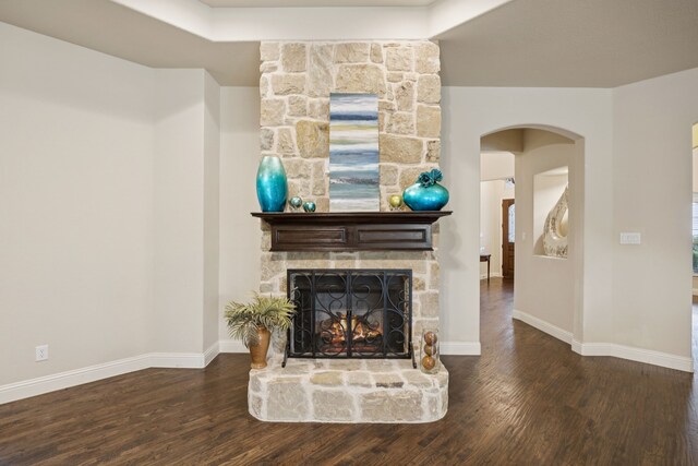 235 Bearclaw Cir, Aledo, TX 76008 - living room with arched walkways, wood finished floors, baseboards, and a stone fireplace