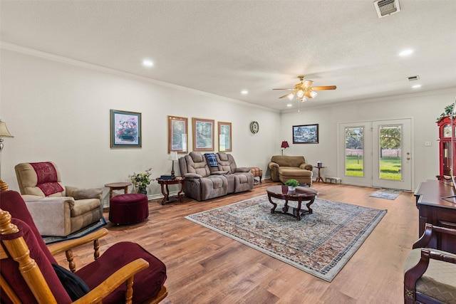 1419 Hinchliffe Rd, Mexia, TX 76667 - living area with ceiling fan, recessed lighting, wood finished floors, crown molding, and a textured ceiling
