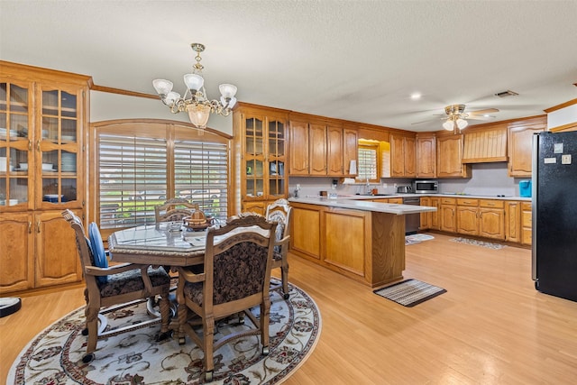 1419 Hinchliffe Rd, Mexia, TX 76667 - kitchen with light countertops, stainless steel appliances, a sink, glass insert cabinets, and light wood finished floors