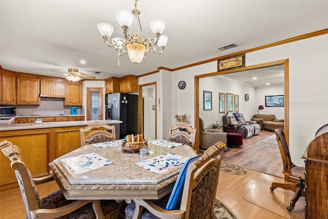 1419 Hinchliffe Rd, Mexia, TX 76667 - dining space featuring light wood finished floors, a chandelier, crown molding, a ceiling fan, and recessed lighting