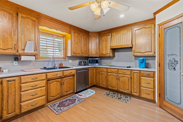1419 Hinchliffe Rd, Mexia, TX 76667 - kitchen featuring appliances with stainless steel finishes, a sink, tasteful backsplash, light wood-type flooring, and light countertops