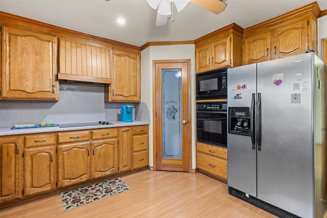 1419 Hinchliffe Rd, Mexia, TX 76667 - kitchen with black appliances, brown cabinetry, a ceiling fan, and light countertops