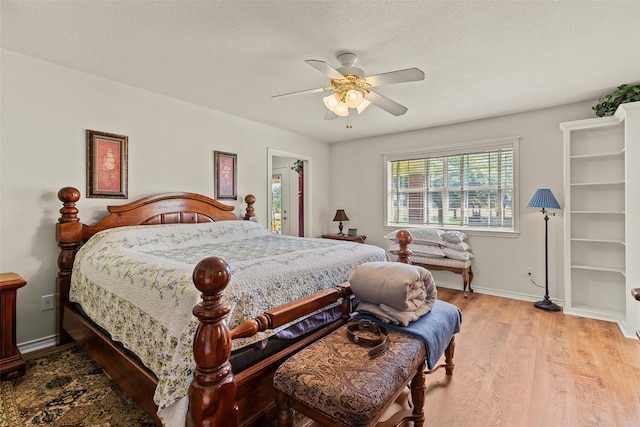 1419 Hinchliffe Rd, Mexia, TX 76667 - bedroom featuring wood finished floors, baseboards, a textured ceiling, and ceiling fan