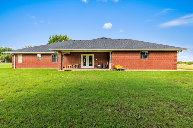 1419 Hinchliffe Rd, Mexia, TX 76667 - rear view of property featuring french doors, a lawn, brick siding, and a patio