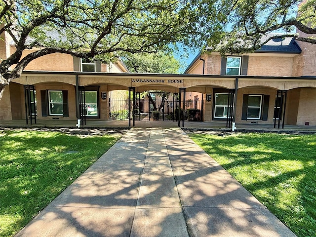 7830 Meadow Park Dr Unit 209, Dallas, TX 75230 - view of front of property featuring brick siding, covered porch, and a gate