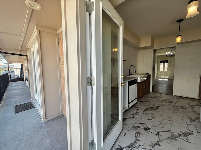 7830 Meadow Park Dr Unit 209, Dallas, TX 75230 - hallway featuring a sink and a chandelier