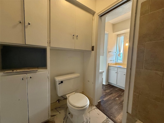 7830 Meadow Park Dr Unit 209, Dallas, TX 75230 - bathroom featuring vanity, toilet, and marble finish flooring