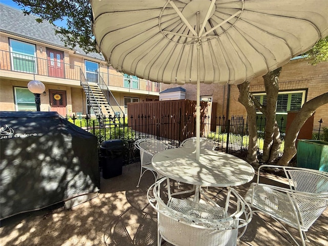 7830 Meadow Park Dr Unit 209, Dallas, TX 75230 - view of patio featuring outdoor dining area and stairs