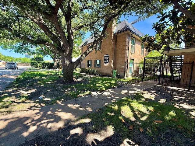 7830 Meadow Park Dr Unit 209, Dallas, TX 75230 - view of side of property with brick siding and a gate