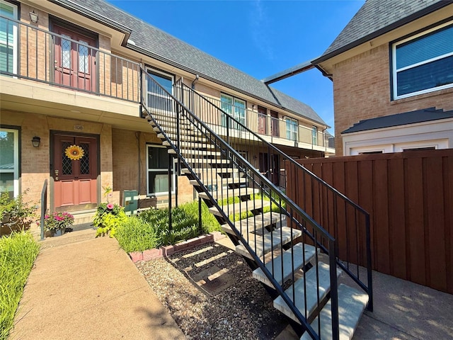 7830 Meadow Park Dr Unit 209, Dallas, TX 75230 - doorway to property with brick siding and a shingled roof