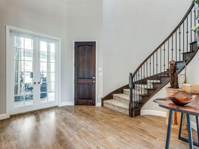 720 Lawndale St, Celina, TX 75009 - foyer with wood finished floors, stairs, baseboards, french doors, and a towering ceiling