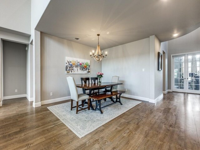 720 Lawndale St, Celina, TX 75009 - living room with a chandelier, wood finished floors, a high ceiling, a stone fireplace, and baseboards