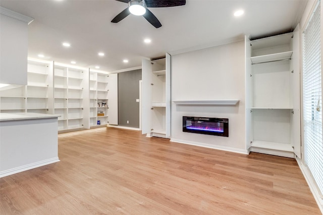 3208 Cole Ave Unit 2203, Dallas, TX 75204 - unfurnished living room featuring ceiling fan, light wood-style flooring, a glass covered fireplace, crown molding, and recessed lighting