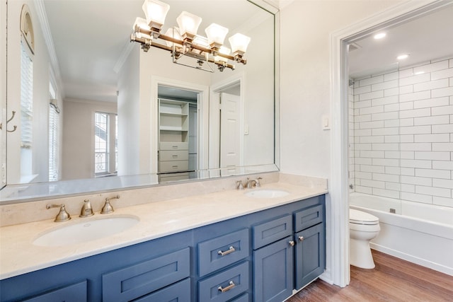 3208 Cole Ave Unit 2203, Dallas, TX 75204 - full bath featuring crown molding, toilet, double vanity, wood finished floors, and  shower combination
