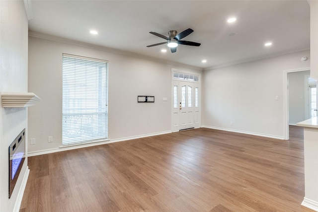 3208 Cole Ave Unit 2203, Dallas, TX 75204 - unfurnished living room featuring a fireplace, a ceiling fan, crown molding, wood finished floors, and baseboards