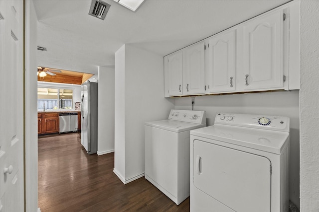 4208 Crestover Dr, Mesquite, TX 75150 - laundry area featuring separate washer and dryer, dark wood-style flooring, and cabinet space