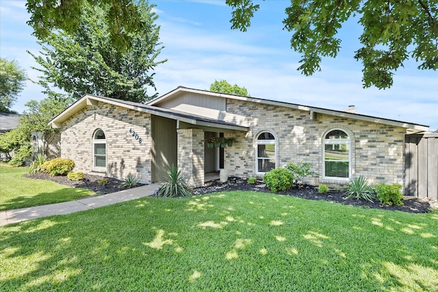 4208 Crestover Dr, Mesquite, TX 75150 - view of front of house featuring a front yard, brick siding, and stone siding