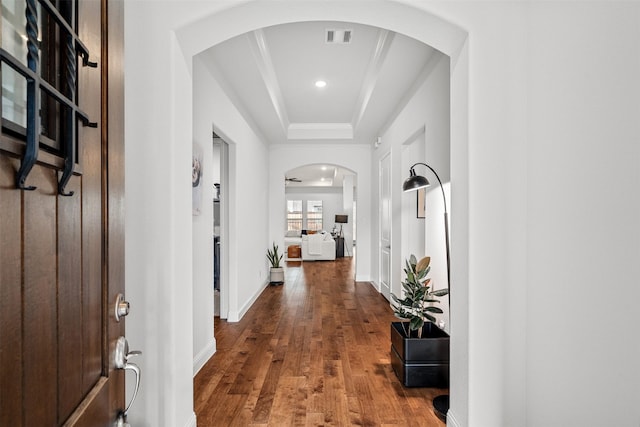 2705 Cumberland, The Colony, TX 75056 - hallway featuring a raised ceiling, wood finished floors, baseboards, recessed lighting, and arched walkways