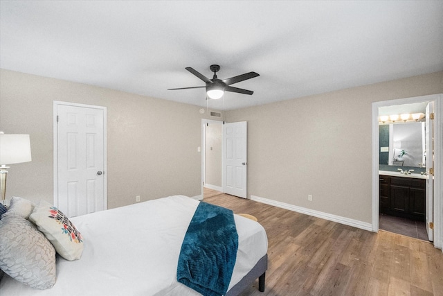 7817 Whirlwind Dr, Fort Worth, TX 76133 - bedroom with light wood-style flooring, baseboards, ensuite bath, and ceiling fan