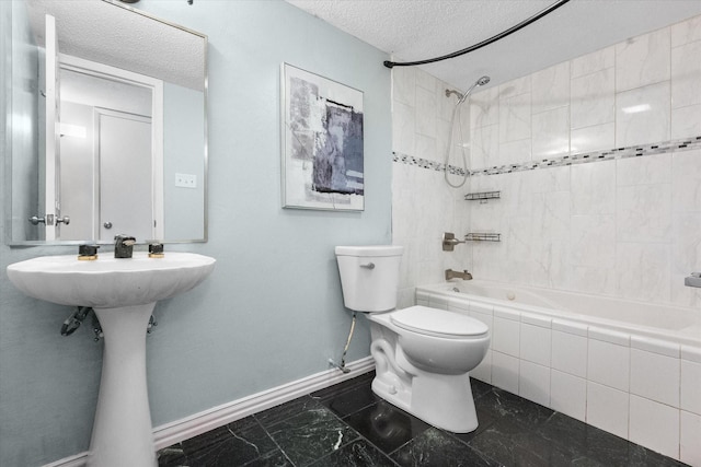 7817 Whirlwind Dr, Fort Worth, TX 76133 - bathroom with baseboards, tiled shower / bath combo, toilet, and a textured ceiling