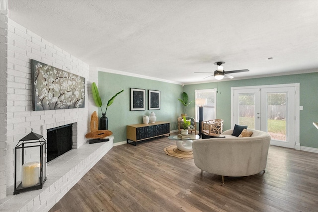 7817 Whirlwind Dr, Fort Worth, TX 76133 - living area featuring a brick fireplace, french doors, wood finished floors, baseboards, and a ceiling fan