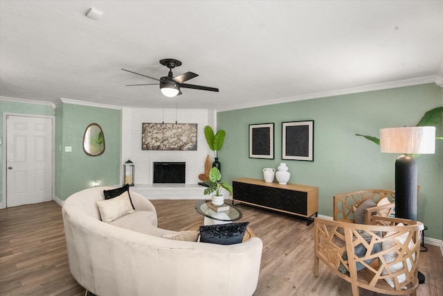 7817 Whirlwind Dr, Fort Worth, TX 76133 - living room with crown molding, ceiling fan, wood finished floors, a brick fireplace, and baseboards