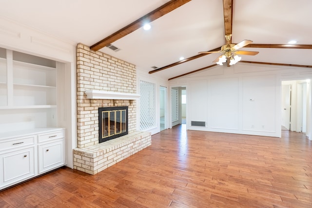 110 Sunview St, Sunnyvale, TX 75182 - unfurnished living room featuring ceiling fan, light wood-style floors, a brick fireplace, and a decorative wall