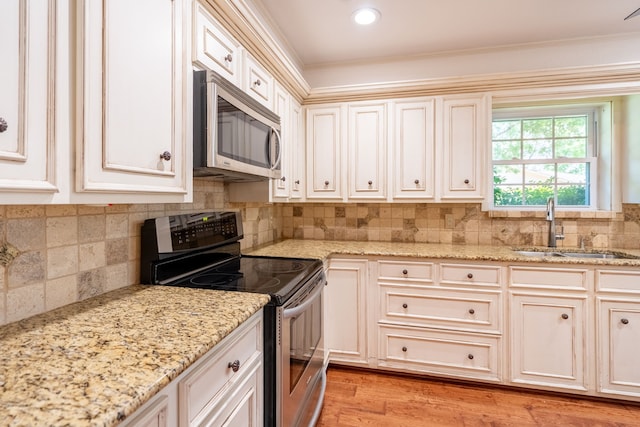 110 Sunview St, Sunnyvale, TX 75182 - kitchen featuring stainless steel appliances, a sink, ornamental molding, tasteful backsplash, and light stone counters