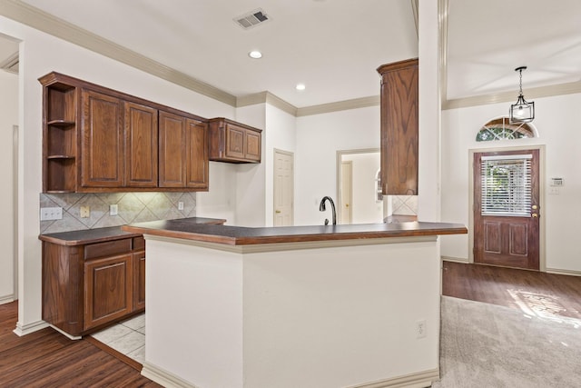 3559 Kayewood Dr, Little Elm, TX 75068 - kitchen featuring dark countertops, ornamental molding, wood finished floors, a sink, and decorative backsplash