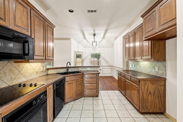 3559 Kayewood Dr, Little Elm, TX 75068 - kitchen featuring black appliances, a sink, dark countertops, brown cabinetry, and light tile patterned floors
