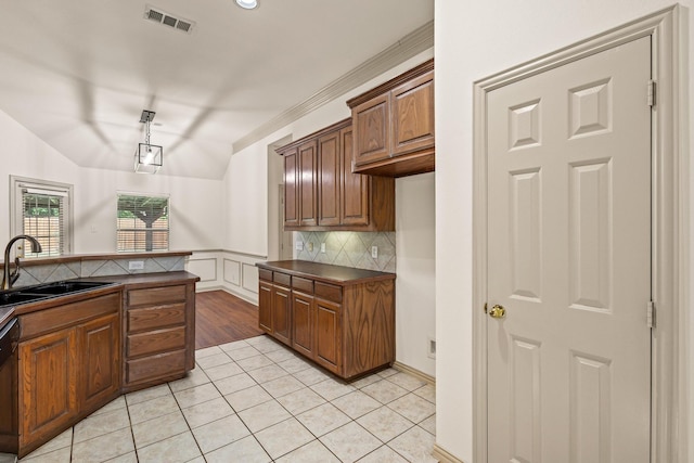 3559 Kayewood Dr, Little Elm, TX 75068 - kitchen with a sink, dark countertops, light tile patterned floors, tasteful backsplash, and black dishwasher