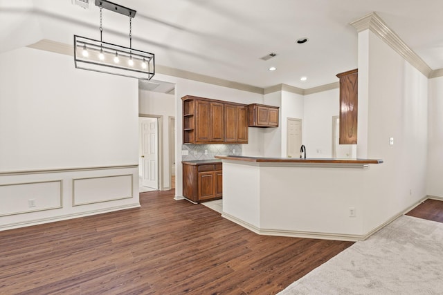 3559 Kayewood Dr, Little Elm, TX 75068 - kitchen with open shelves, wood finished floors, ornamental molding, backsplash, and brown cabinetry
