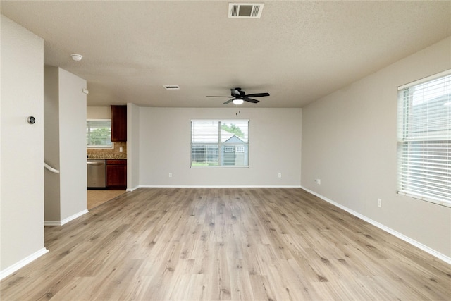 2133 Bliss Rd, Fort Worth, TX 76177 - unfurnished living room with light wood-style floors, a ceiling fan, plenty of natural light, and a textured ceiling