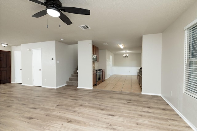 2133 Bliss Rd, Fort Worth, TX 76177 - unfurnished living room with light wood-style floors, stairs, a chandelier, ceiling fan, and baseboards