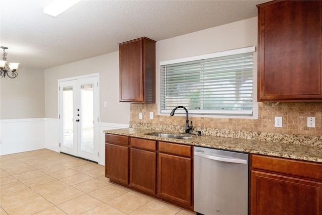 2133 Bliss Rd, Fort Worth, TX 76177 - kitchen with stainless steel dishwasher, a sink, french doors, light stone counters, and decorative backsplash