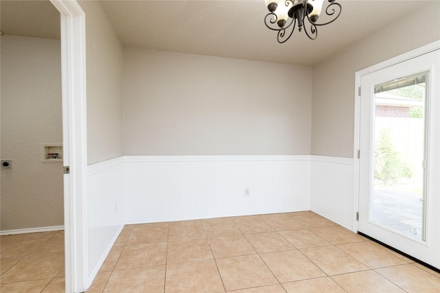 2133 Bliss Rd, Fort Worth, TX 76177 - unfurnished dining area with a wainscoted wall, a chandelier, and light tile patterned floors