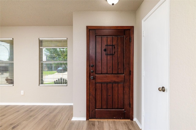 2133 Bliss Rd, Fort Worth, TX 76177 - foyer featuring light wood finished floors, baseboards, and a textured ceiling