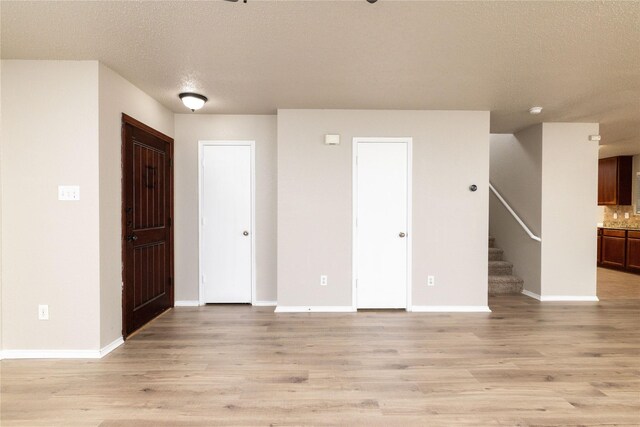 2133 Bliss Rd, Fort Worth, TX 76177 - entryway featuring light wood-style flooring, stairway, baseboards, and a textured ceiling