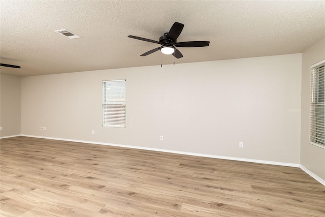 2133 Bliss Rd, Fort Worth, TX 76177 - empty room featuring a ceiling fan, light wood-style flooring, baseboards, and a textured ceiling