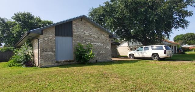 918 Greenbriar Dr, Garland, TX 75043 - view of side of home featuring a yard and brick siding