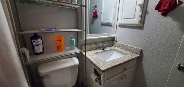 918 Greenbriar Dr, Garland, TX 75043 - bathroom with vanity, toilet, and a textured wall